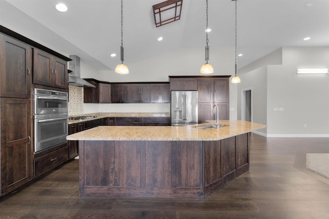 kitchen with stainless steel appliances, a spacious island, a sink, dark brown cabinets, and wall chimney range hood