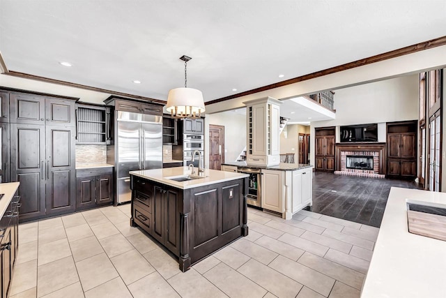 kitchen with beverage cooler, light countertops, appliances with stainless steel finishes, and a sink