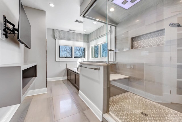 bathroom featuring recessed lighting, visible vents, vanity, tiled shower, and baseboards