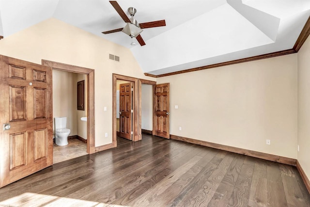 unfurnished bedroom with lofted ceiling, visible vents, baseboards, and wood finished floors