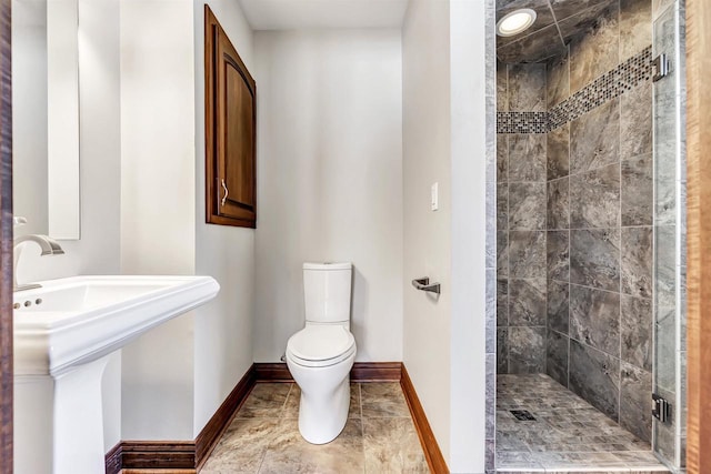 full bathroom with toilet, a stall shower, tile patterned flooring, and baseboards