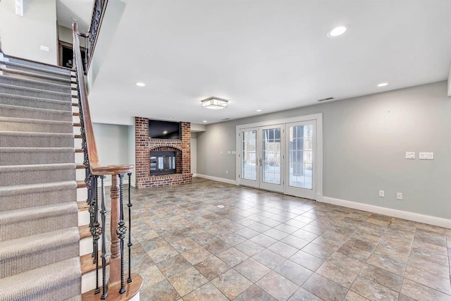 unfurnished living room featuring recessed lighting, french doors, baseboards, and stairs