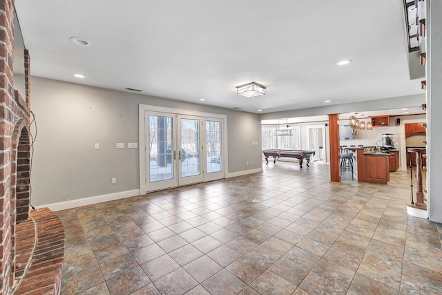 unfurnished living room with billiards, visible vents, baseboards, french doors, and recessed lighting