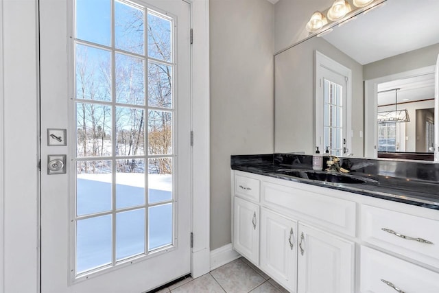 bathroom with a healthy amount of sunlight, vanity, and tile patterned floors