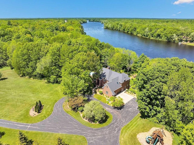 drone / aerial view featuring a water view and a wooded view