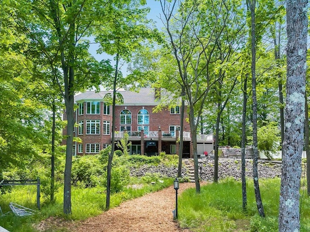 exterior space featuring a deck and brick siding