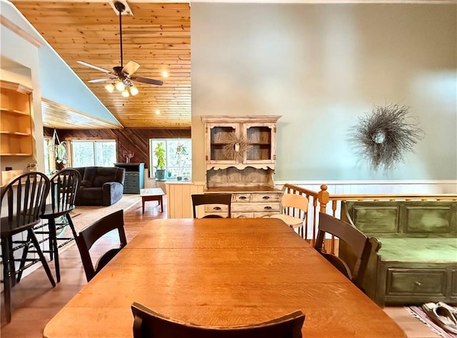 dining area with high vaulted ceiling, wooden ceiling, ceiling fan, and wood finished floors