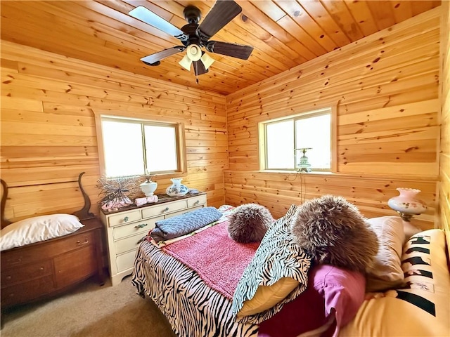 bedroom with wooden ceiling, carpet, ceiling fan, and wood walls