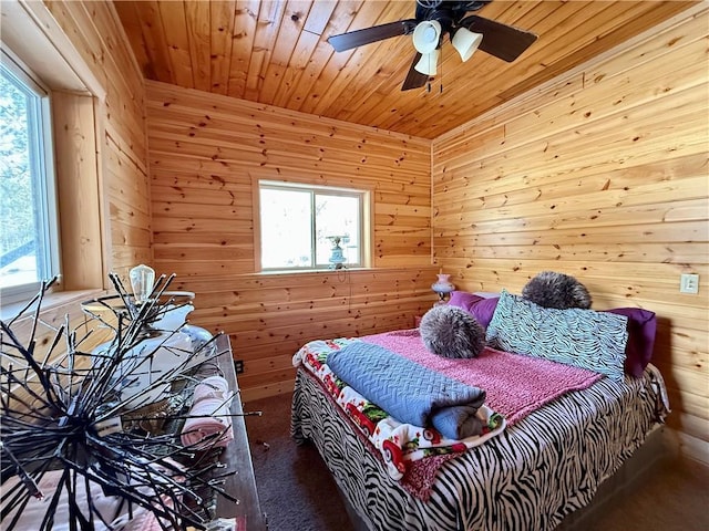 bedroom featuring carpet floors, wooden ceiling, a ceiling fan, and wooden walls