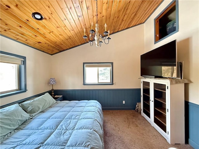 bedroom with wooden ceiling, vaulted ceiling, carpet flooring, and wainscoting