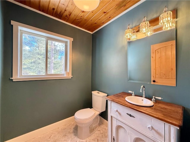 bathroom with toilet, wood ceiling, baseboards, vanity, and crown molding