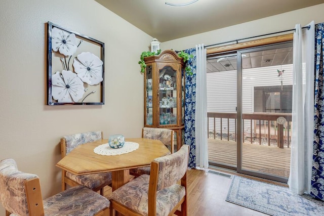 dining room with visible vents and wood finished floors