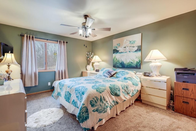 carpeted bedroom with baseboards and a ceiling fan