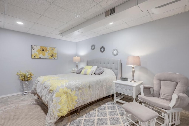 bedroom with a paneled ceiling, recessed lighting, visible vents, and baseboards