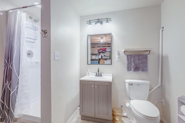 full bathroom featuring a stall shower, vanity, and toilet