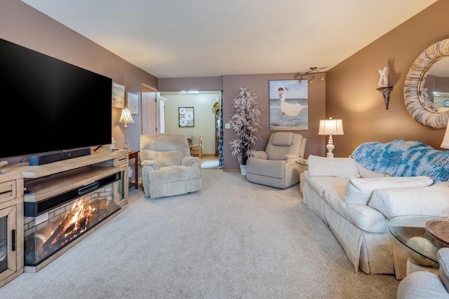 carpeted living room with a warm lit fireplace