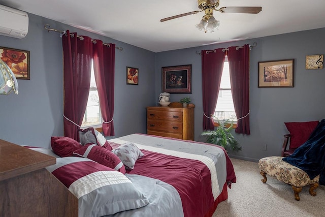 carpeted bedroom with ceiling fan, baseboards, and a wall mounted AC