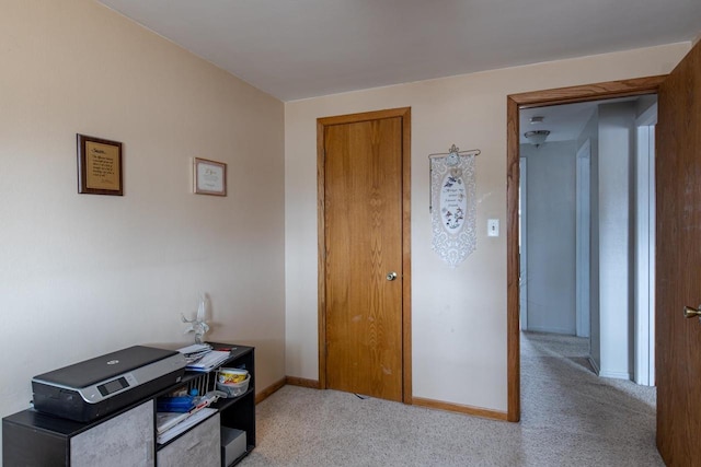 carpeted office space featuring baseboards