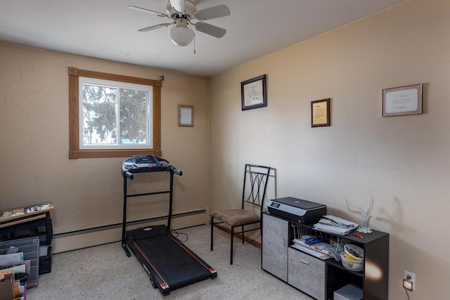 workout room featuring ceiling fan and a baseboard heating unit