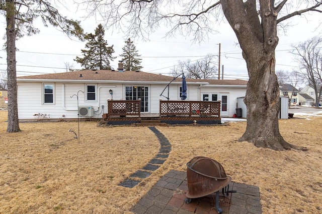 back of property with ac unit, a lawn, and a deck