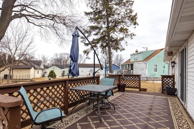 view of patio / terrace with a residential view, outdoor dining area, and a wooden deck