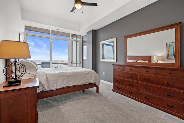 carpeted bedroom featuring visible vents, baseboards, and a ceiling fan