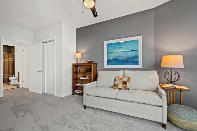 sitting room with ceiling fan and carpet floors