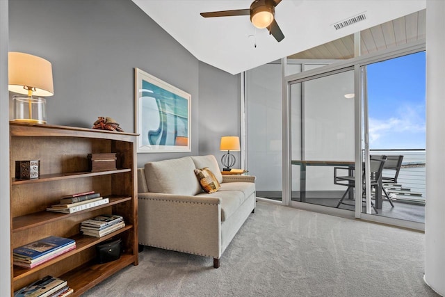 living area featuring a ceiling fan, carpet, and visible vents