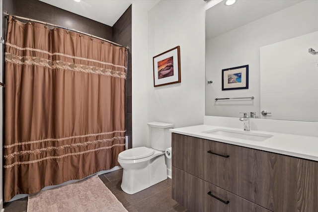 full bathroom featuring a shower with curtain, vanity, toilet, and tile patterned floors