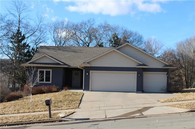 ranch-style house with an attached garage and concrete driveway