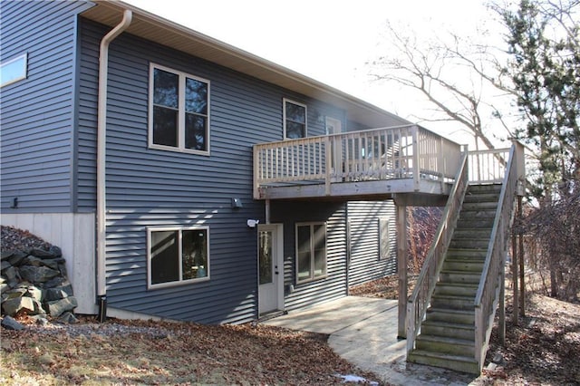 back of property with a patio and stairway