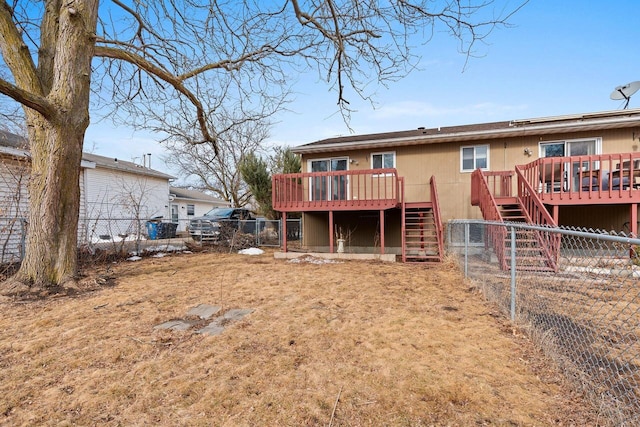 back of house featuring fence, stairway, and a wooden deck