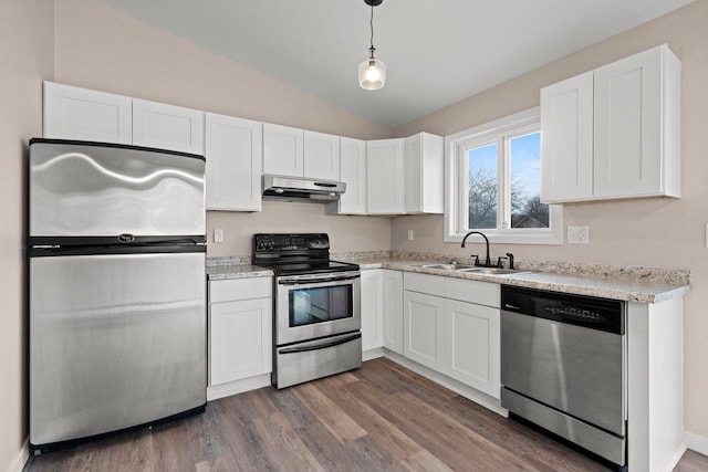 kitchen featuring appliances with stainless steel finishes, wood finished floors, under cabinet range hood, white cabinetry, and a sink