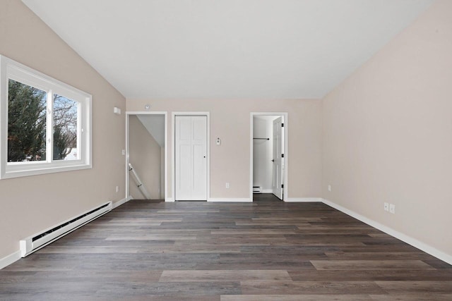 unfurnished bedroom featuring baseboard heating, wood finished floors, and baseboards