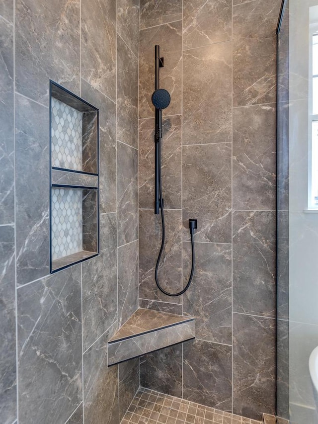 full bathroom with a tile shower