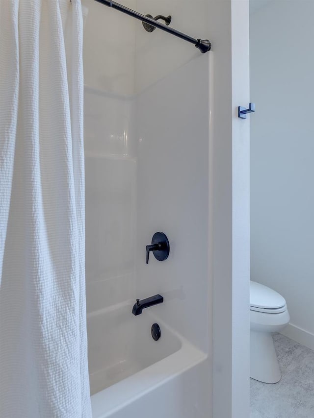 bathroom featuring toilet and shower / bath combination with curtain