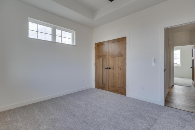 unfurnished bedroom featuring carpet floors and baseboards