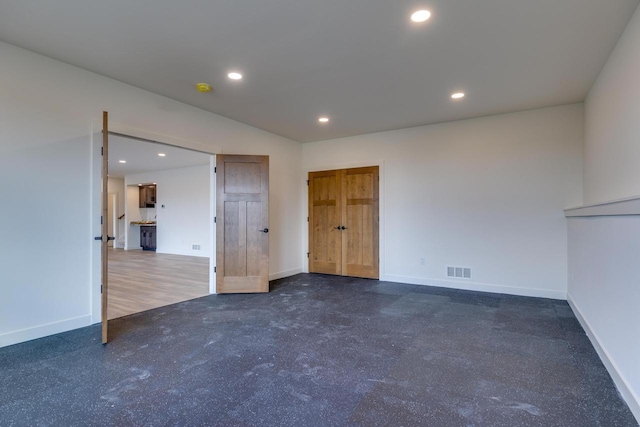 unfurnished room with baseboards, visible vents, and recessed lighting