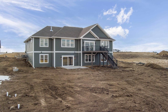 back of house with a deck and stairway