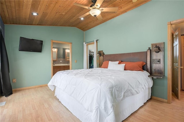 bedroom featuring light wood-type flooring, a walk in closet, wooden ceiling, and vaulted ceiling