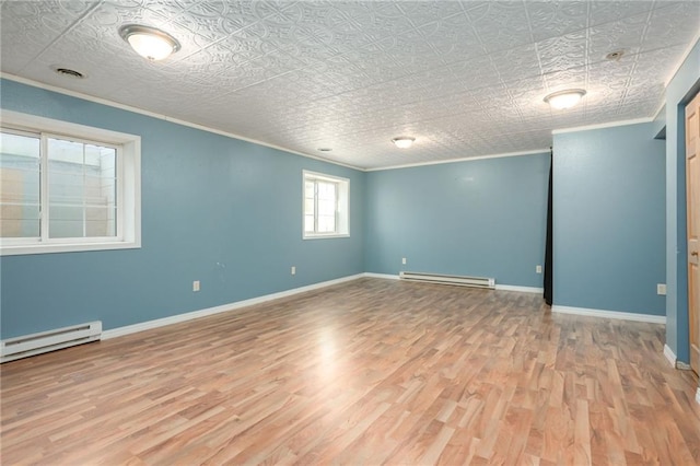 empty room featuring ornamental molding, a baseboard radiator, and wood finished floors