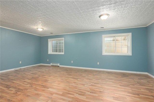 empty room featuring baseboards, baseboard heating, wood finished floors, and ornamental molding