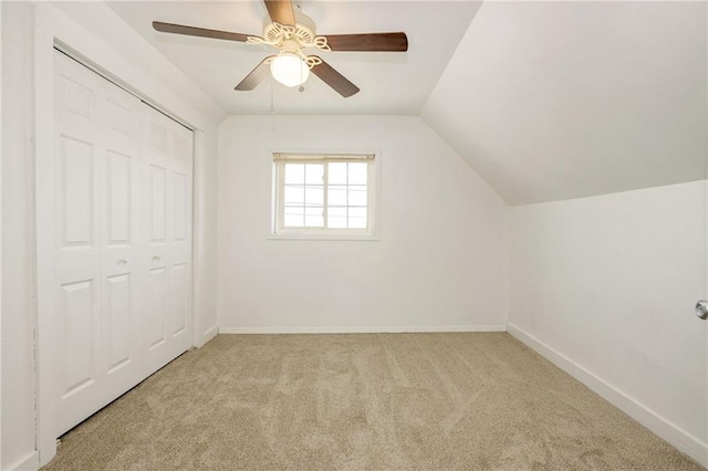 additional living space featuring a ceiling fan, carpet, vaulted ceiling, and baseboards