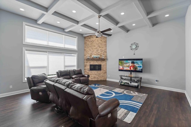 living area featuring a stone fireplace, wood finished floors, baseboards, and coffered ceiling