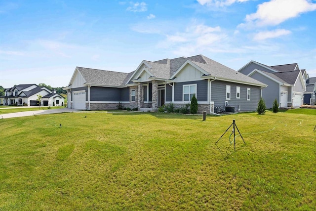 craftsman-style house featuring a garage, board and batten siding, a front lawn, and central AC