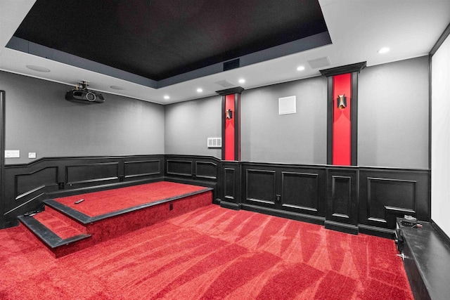 interior space featuring a tray ceiling, recessed lighting, and carpet floors