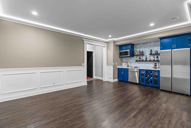 bar with backsplash, recessed lighting, wet bar, stainless steel appliances, and dark wood-style flooring