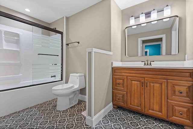 full bath featuring vanity, baseboards, tile patterned flooring, toilet, and combined bath / shower with glass door