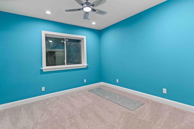 unfurnished room featuring carpet flooring, a ceiling fan, and baseboards