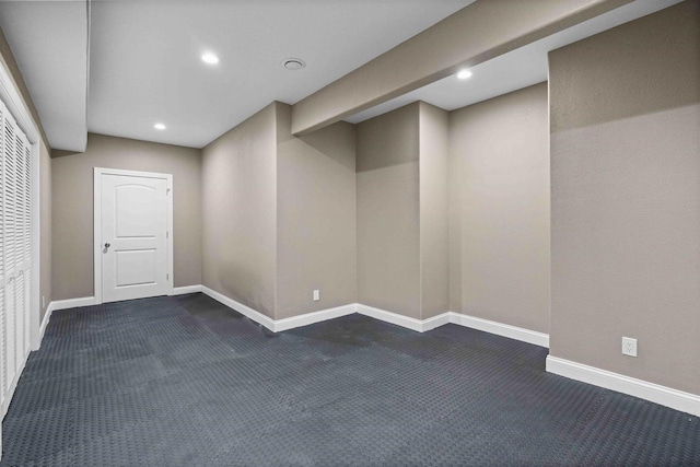 basement with dark colored carpet, baseboards, and recessed lighting